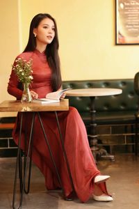 Discover Vietnamese Ao Dai Beauty: Elegant, Graceful Girl in a Cafe Setting-19