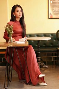 Discover Vietnamese Ao Dai Beauty: Elegant, Graceful Girl in a Cafe Setting-0