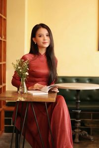 Discover Vietnamese Ao Dai Beauty: Elegant, Graceful Girl in a Cafe Setting-2