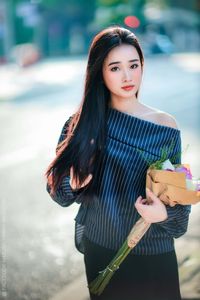 Elegant Beauty Charming Vietnamese Girl with Fresh Flowers on Street Captivating Street Fashion Style-6