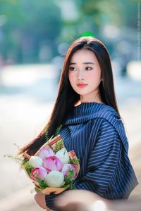Elegant Beauty Charming Vietnamese Girl with Fresh Flowers on Street Captivating Street Fashion Style-3
