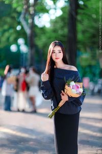 Elegant Beauty Charming Vietnamese Girl with Fresh Flowers on Street Captivating Street Fashion Style-4