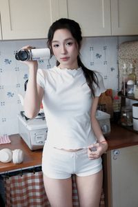 Young Woman Relaxing with Headphones & Music in Cozy Kitchen: Serene Home Lifestyle Moment-9