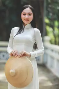 Elegant Vietnamese Woman in White Ao Dai: A Portrait of Traditional Grace and Conical Hat-6