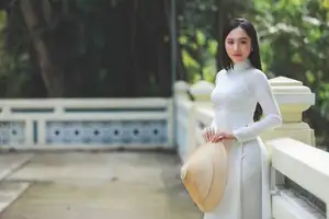 Elegant Vietnamese Woman in White Ao Dai: A Portrait of Traditional Grace and Conical Hat-1