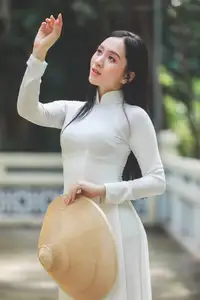 Elegant Vietnamese Woman in White Ao Dai: A Portrait of Traditional Grace and Conical Hat-0