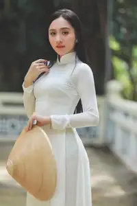 Elegant Vietnamese Woman in White Ao Dai: A Portrait of Traditional Grace and Conical Hat-3