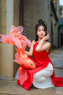 Vietnamese Cultural Beauty: Girl in Red Ao Dai & Traditional Lion Dance Prop-1