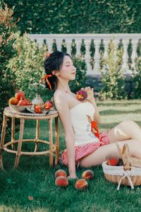 Beautiful Woman Enjoying Fresh Summer Peaches in a Lush Garden Setting, Healthy Lifestyle Inspiration.-8