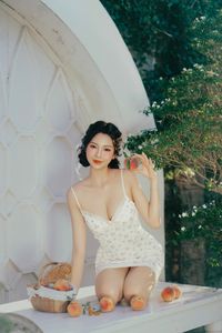 Beautiful Woman Enjoying Fresh Summer Peaches in a Lush Garden Setting, Healthy Lifestyle Inspiration.-2