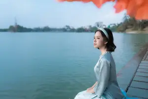 Serene Beauty: Vietnamese Young Woman by the Lake in Traditional Attire-4