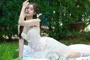 Ethereal Beauty: Young Woman in White Amidst Lush Green Nature-1