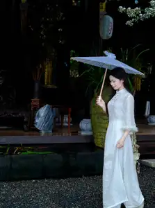 Graceful Vietnamese Woman in White Ao Dai with Lotus Flower in Serene Garden-3