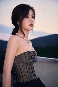 Rooftop Glamour: Elegant Woman Shines in Chic Black Dress, Captivating All Eyes with Effortless Style.-1