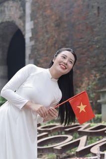 Elegant Vietnamese Woman in White Ao Dai Embracing Spirit of Independence-0