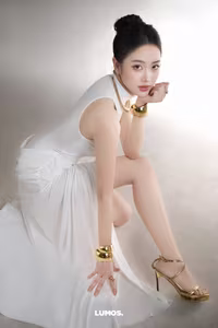 VGU No.53: Elegant beauty in a pristine white dress, posing glamorously on a luxurious black chair. Explore the sophisticated style of the modern woman.-8