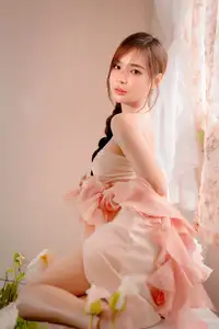 Ethereal Beauty: A Young Woman's Delicate Charm in a Flowing Pink Dress-0