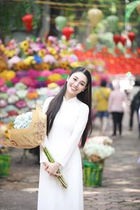Elegant Vietnamese Ao Dai Beauty Amidst Vibrant Flower Market: Youthful Charm-4