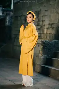 Discover the Graceful Beauty of a Vietnamese Woman in Radiant Yellow Ao Dai with Pure Lotus 1000025235-7