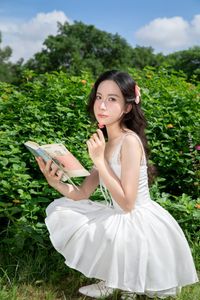 Elegant Young Woman in White Dress Amidst Greenery | Natural Summer Beauty-4