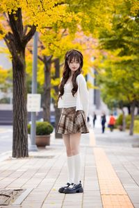 Young Asian Girl in Plaid Skirt Embracing Autumn Foliage-15
