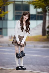 Young Asian Girl in Plaid Skirt Embracing Autumn Foliage-3