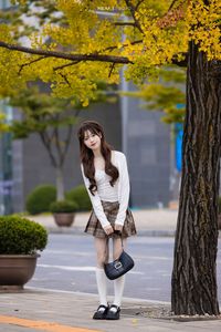 Young Asian Girl in Plaid Skirt Embracing Autumn Foliage-17
