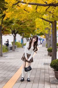 Young Asian Girl in Plaid Skirt Embracing Autumn Foliage-4