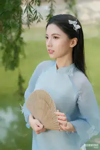 Elegant Vietnamese Maiden in Áo Dài Amidst Serene Nature's Embrace-0