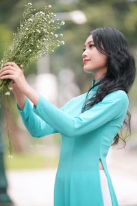 Vietnamese Ao Dai Beauty: Graceful Girl with Flowers.-5