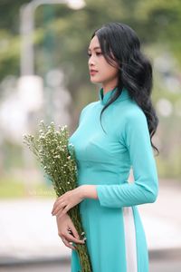 Vietnamese Ao Dai Beauty: Graceful Girl with Flowers.-3