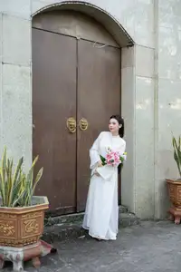 Serene Vietnamese Beauty: A Gentle Muse in White with Pink Lilies-10