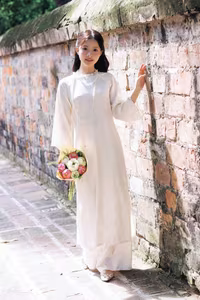 VGU No.131: Graceful young woman in traditional dress, timeless Vietnamese beauty against ancient brick.-6