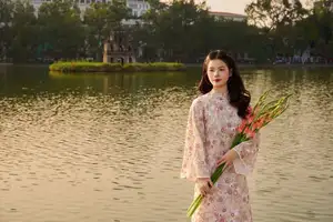 Vietnamese Ao Dai Beauty by the Lake at Sunset: Graceful Girl with Vibrant Gladiolus Flowers.-4