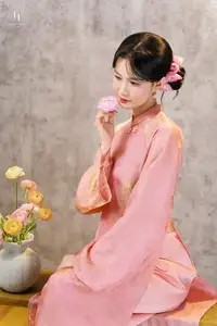 Elegant Asian Charm: Serene Young Woman in Traditional Pink Attire with Delicate Fresh Flowers-6