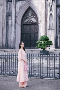 Elegant Woman in Pink Ao Dai at Hanoi Grand Cathedral - Vietnamese Cultural Charm-14