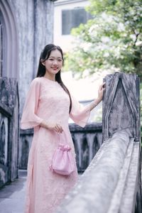 Elegant Woman in Pink Ao Dai at Hanoi Grand Cathedral - Vietnamese Cultural Charm-13
