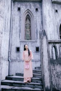 Elegant Woman in Pink Ao Dai at Hanoi Grand Cathedral - Vietnamese Cultural Charm-11