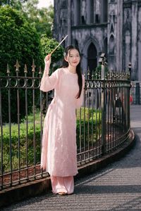 Elegant Woman in Pink Ao Dai at Hanoi Grand Cathedral - Vietnamese Cultural Charm-15