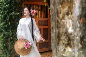 Captivating Asian Beauty: Discover the Ethereal Charm of a Maiden in White with a Blossom in Her Hair.-1
