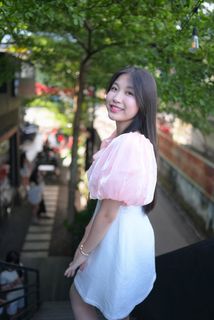 Radiant smile of a young, elegant Vietnamese girl in a pink and white dress.-11