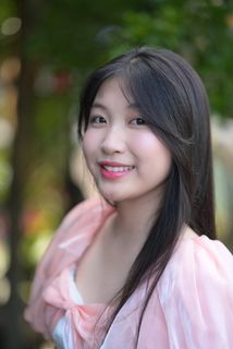 Radiant smile of a young, elegant Vietnamese girl in a pink and white dress.-7