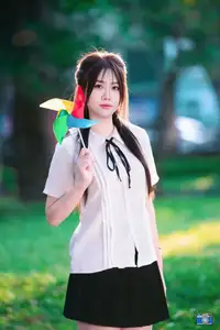 Radiant Youth: Vietnamese Girl's Bright Smile with Pinwheel in Golden Sunlight-0