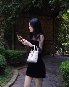 XVG No.3: Elegant Girl in Black Dress Amidst Ancient Garden Charm-1