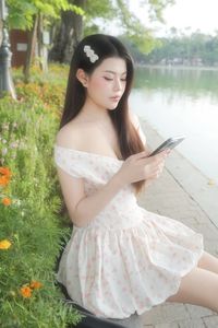 Graceful Woman in White Floral Dress Amidst Serene Summer Nature-4