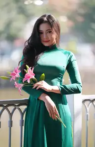 Vietnamese Grace: Elegant Woman in Green Ao Dai with Pink Lotus Flower 1000025232-4