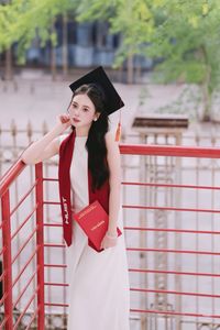 Beautiful Female Graduate Embraces Success at Graduation Ceremony-2