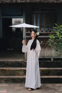 Discover the Grace of a Vietnamese Woman in White Ao Dai with Elegant Lilies-3