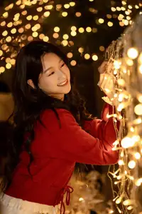 Radiant Smile Girl in Red Amidst Twinkling Lights: Warm Beauty for Festive Season-0