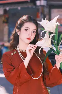 Elegant Vietnamese Beauty: A Girl in Red Ao Dai with Lilies Captivates Urban Charm-0
